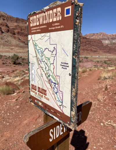 Sidewinder Trail Marker with mountains and trail in background